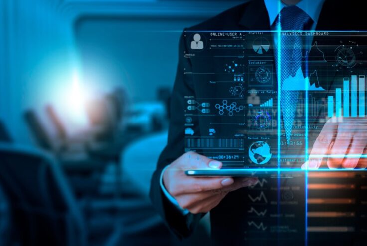 man-in-a-suit-standing-behind-a-hologram-of-data-analytics-1030x579-1